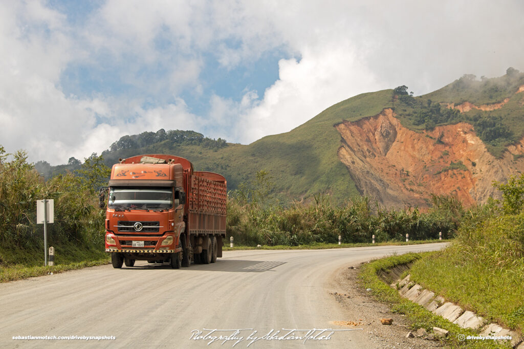 Chinese Truck on Road 13 Erosion visible in Background Laos Drive-by Snapshot by Sebastian MotschChinese Truck on Road 13 Erosion visible in Background Laos Drive-by Snapshot by Sebastian Motsch