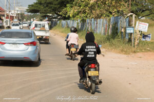 Design Clothing for Jesus Scooter in Traffic Laos Vientiane Drive-by Snapshots by Sebastian Motsch