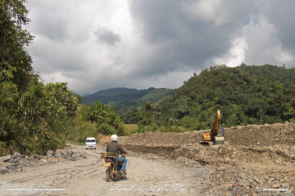 Roadworks on Road 13 Scooter and Toyota Hiace Commuter Laos Drive-by Snapshot by Sebastian Motsch