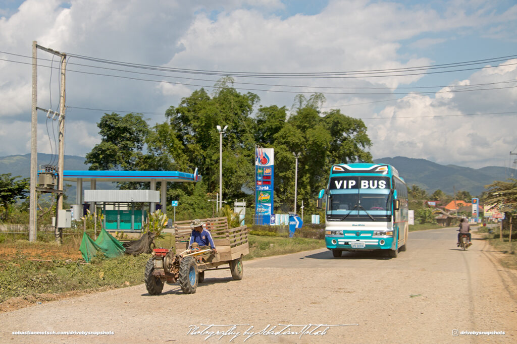 Small Tractor and VIP Bus on Road 13 Laos Drive-by Snapshot by Sebastian Motsch