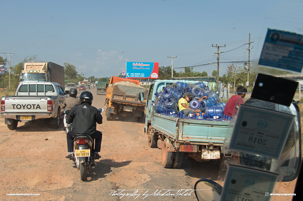 Street Scene with Trucks and Scooters Laos Drive-by Snapshots by Sebastian Motsch