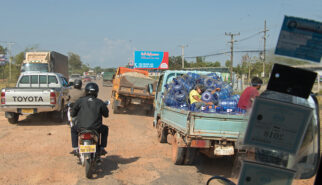 Street Scene with Trucks and Scooters Laos Drive-by Snapshots by Sebastian Motsch