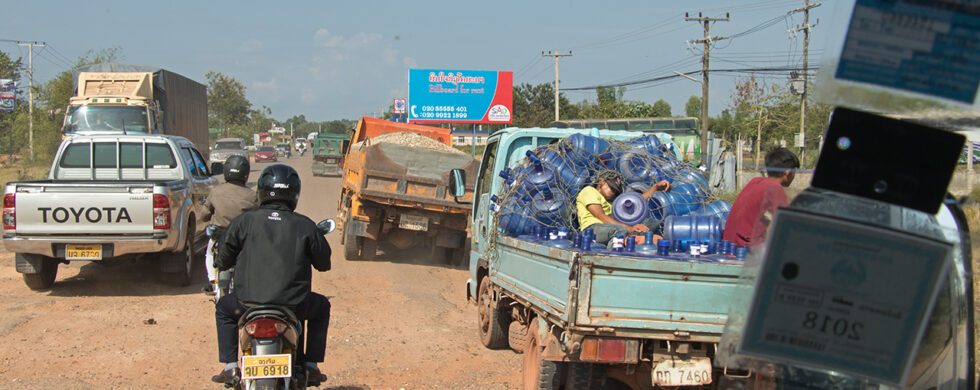 Street Scene with Trucks and Scooters Laos Drive-by Snapshots by Sebastian Motsch