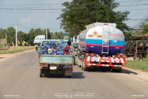 Street Scene with two Trucks Laos Drive-by Snapshots by Sebastian Motsch