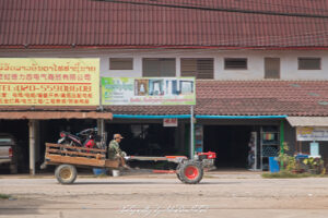 Tractor with Scooter Load Luang Prabang Laos Drive-by Snapshot by Sebastian Motsch