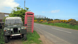 Land Rover Series II SWB Scotland with Red Telephone Booth Drive-by Snapshot by Sebastian Motsch