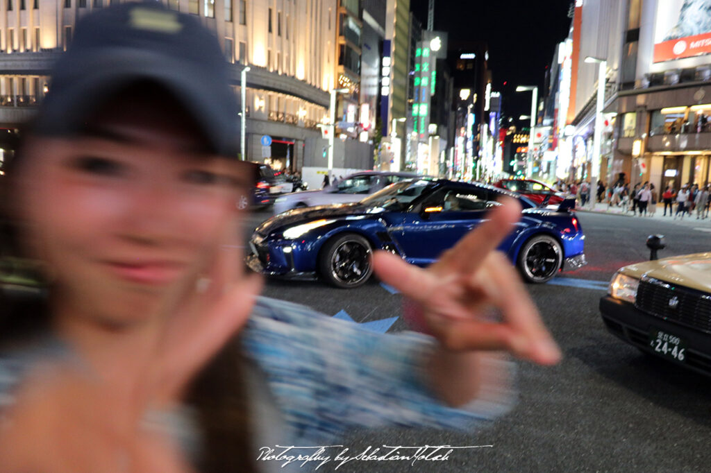Girl photobomb at Nissan Crossing in Ginza Tokyo Japan by Sebastian Motsch