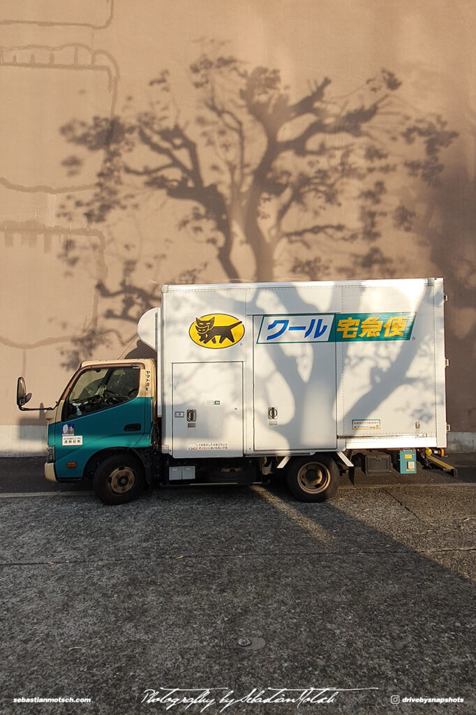 Yamato Delivery Truck with Tree Shadow near Tokyo Tower Photo by Sebastian Motsch